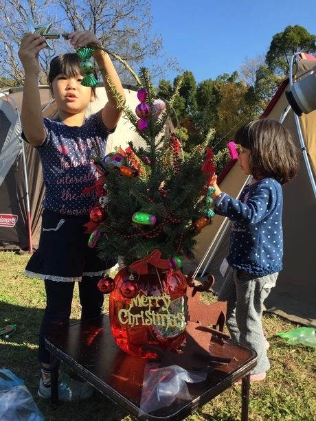 クリスマスツリーに飾りをする子供
